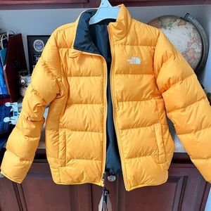 Brand new The north face boys jacket size 10/12 medium reversible yellow/nave.